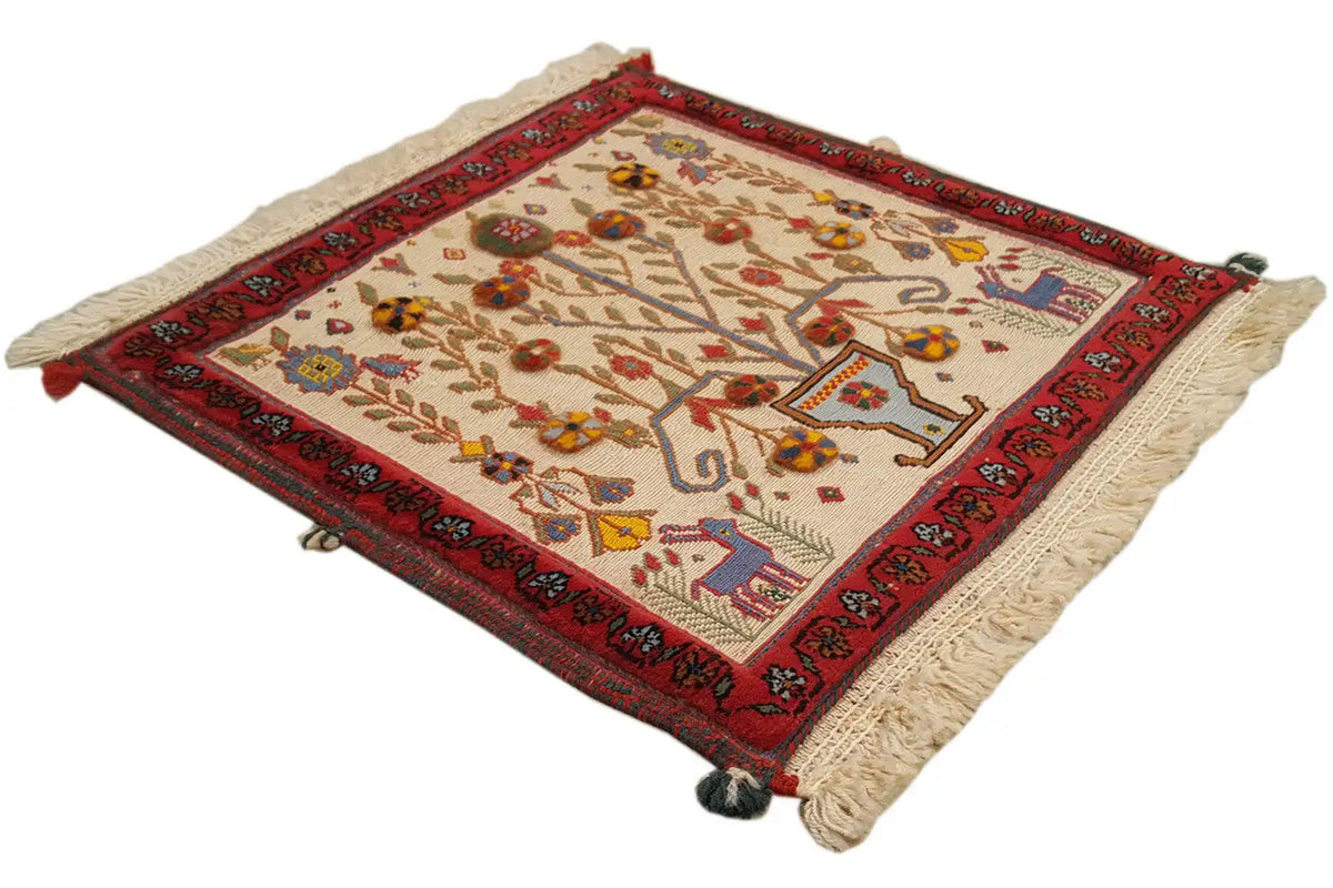 Square decorative cushion cover with red trim, tree and animal motifs, corner tassels