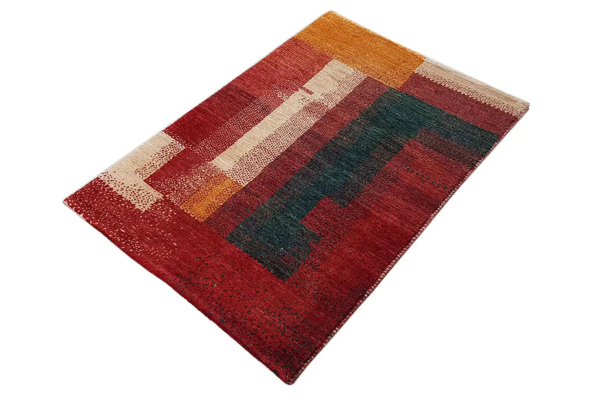 Gabbeh rug (89x60 cm) spread out diagonally, geometric patchwork design in red