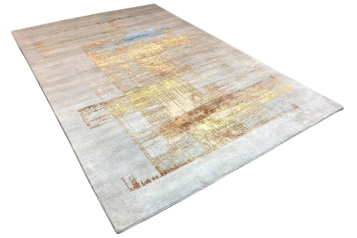 Designer rug with an abstract patchwork pattern, light gray-beige with gold and blue hues