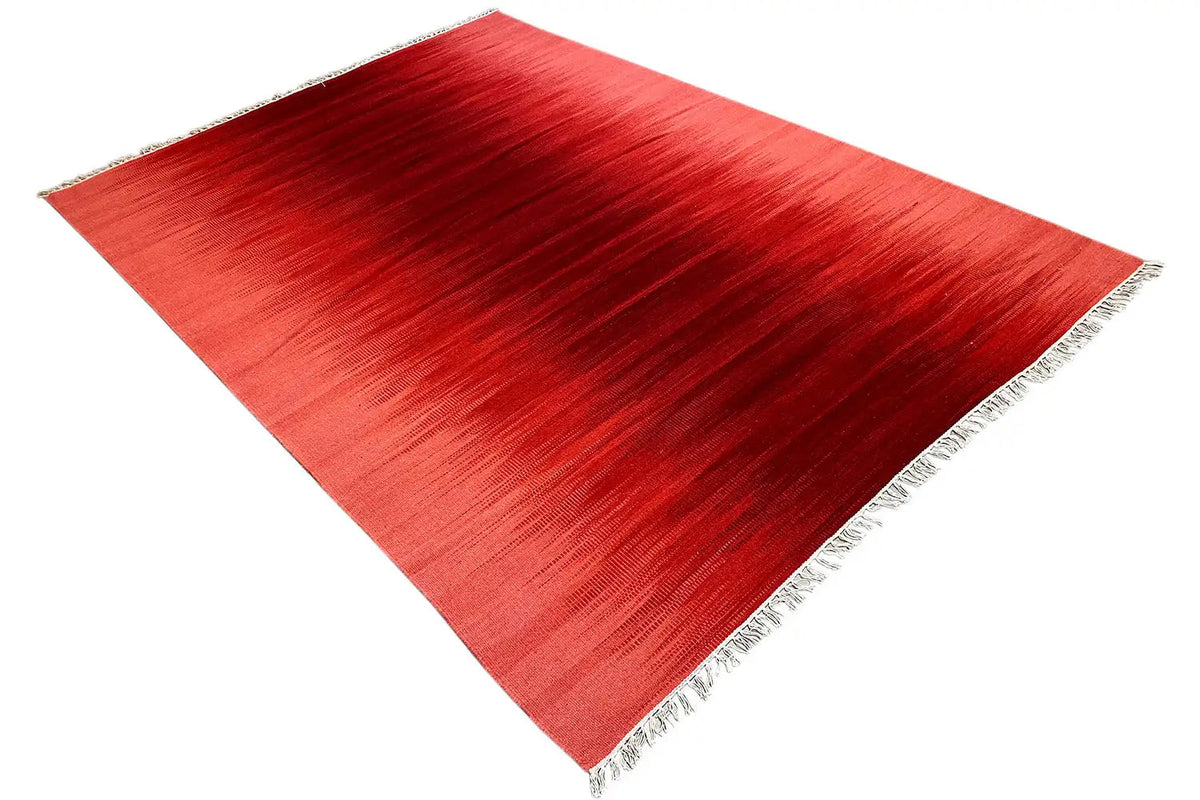 Red kilim rug, diagonal view of the pile and fringed corners