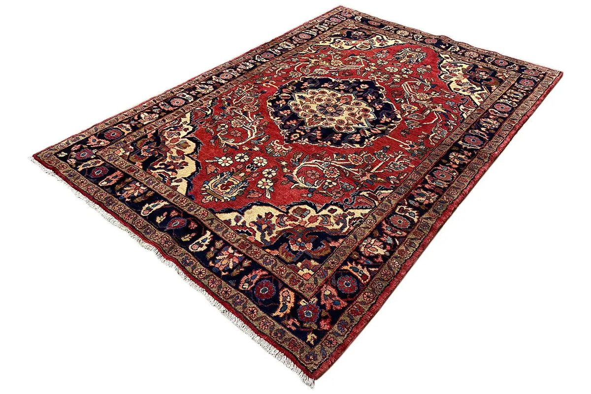 Rug with a red field and blue-and-gold ornaments, central medallion, border