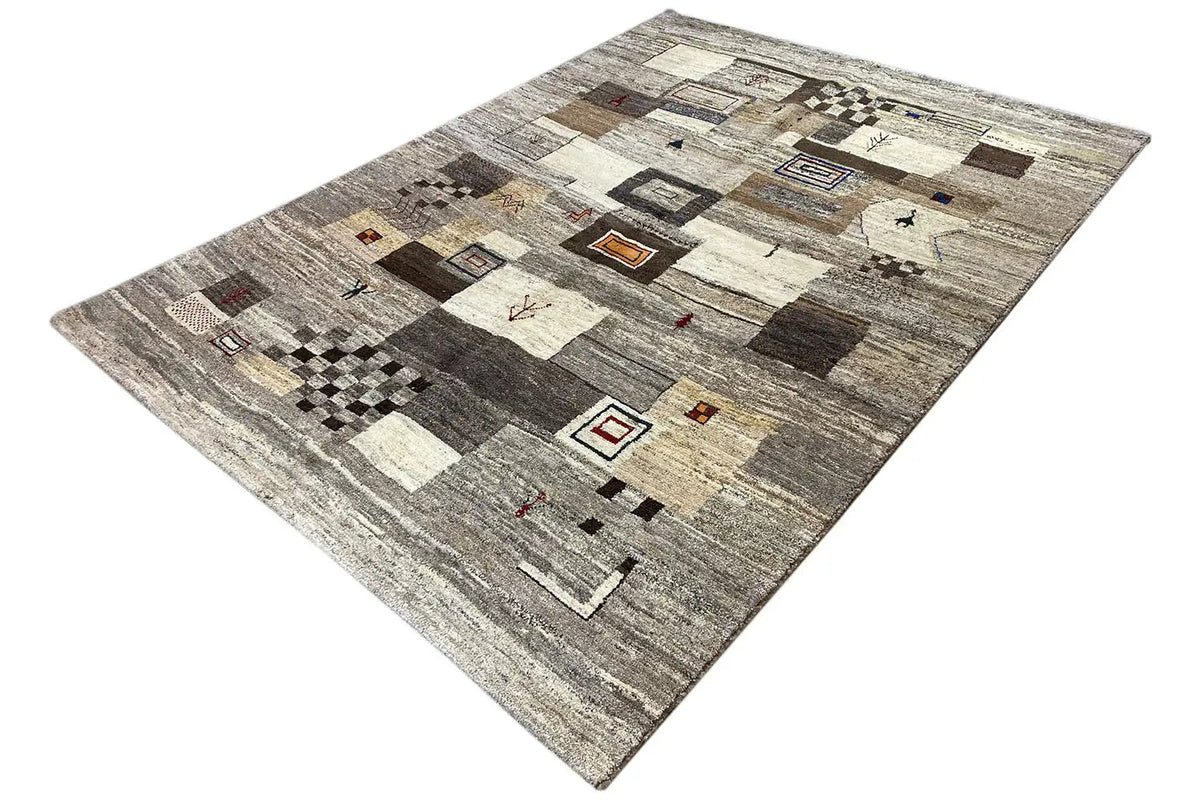 Rectangular rug with a patchwork design of squares in gray, beige, and brown
