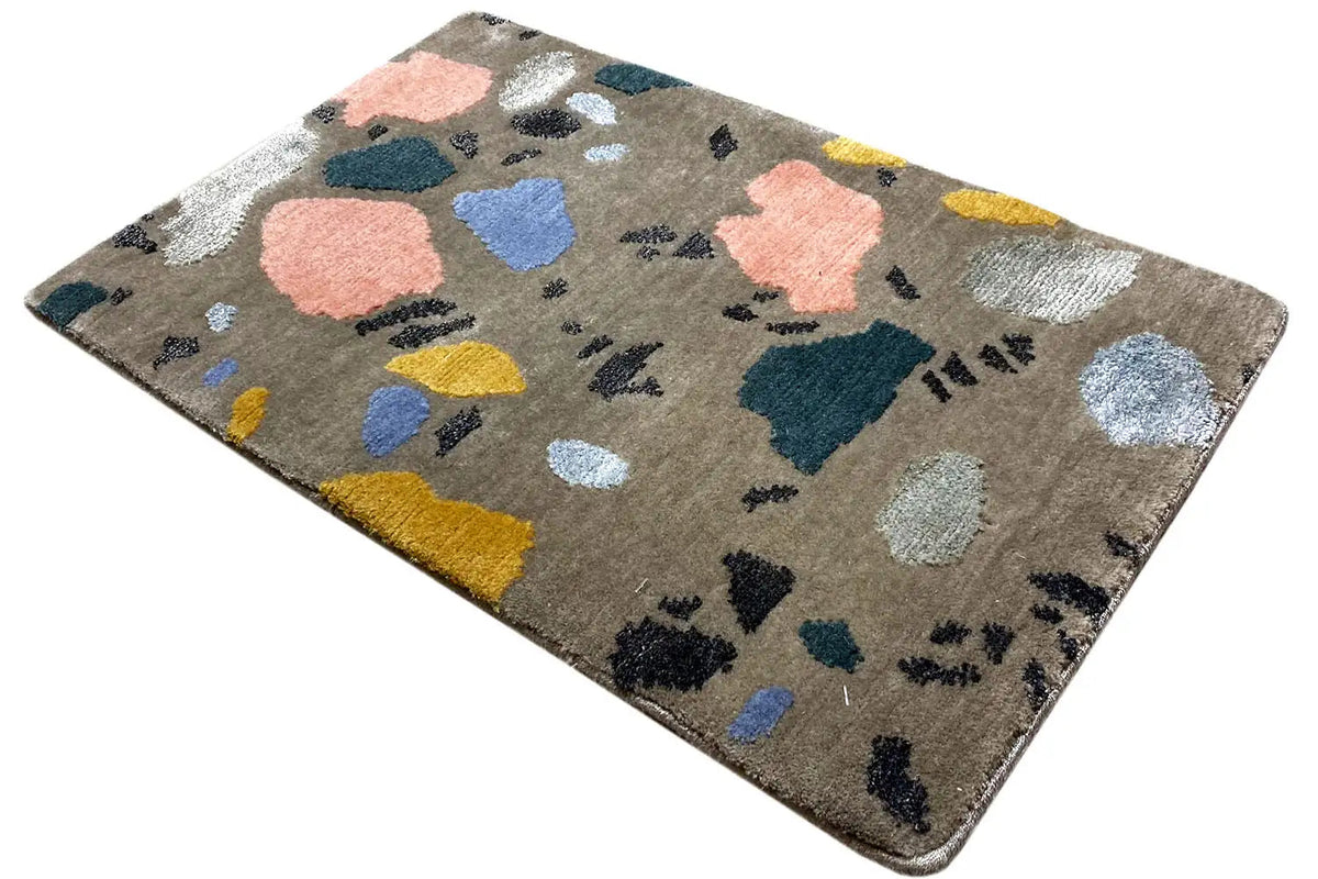 Beige rug with an abstract pattern of color blocks and dark dots, rectangular