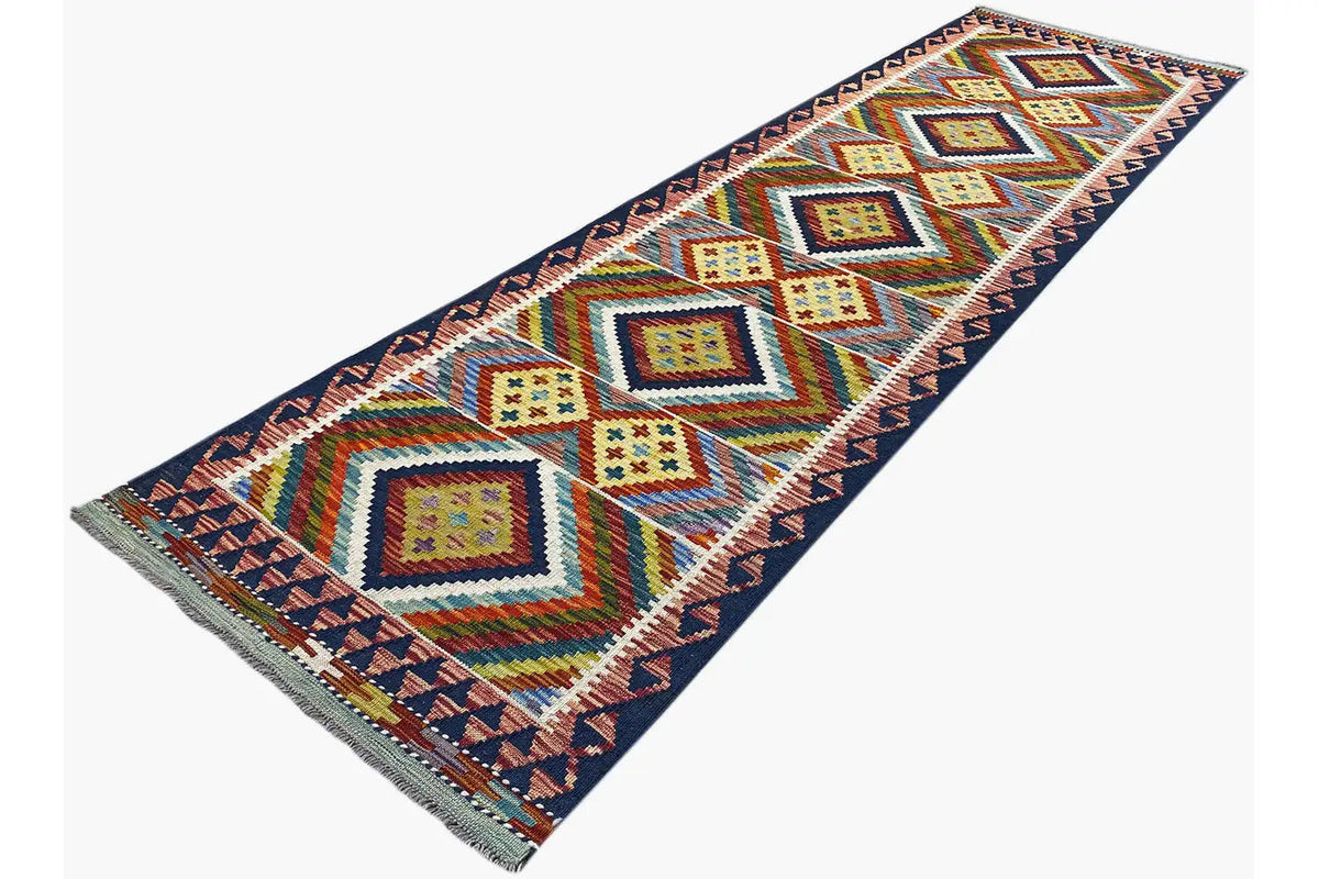 Kelim Afghan runner with a colorful diamond lattice and zigzag border, diagonal view
