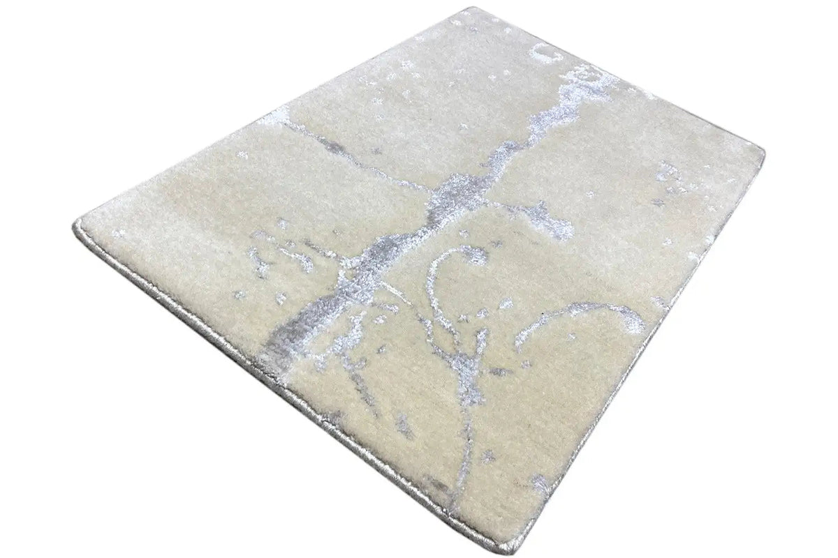 Designer rug 60x40 cm: beige rug with a blue cross and line pattern.