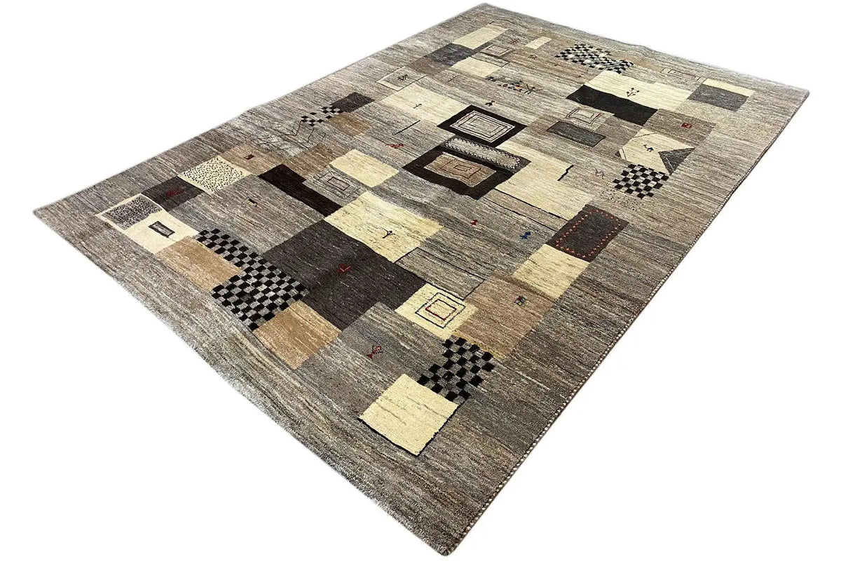 Gabbeh rug in a diagonal view with rectangles and diamonds in beige, gray, and black