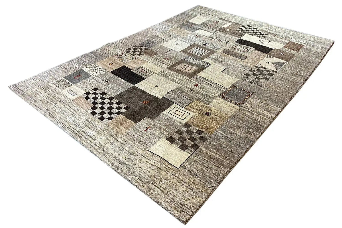 Gabbeh rug, diagonal view: patches and ornaments in gray, beige, and brown