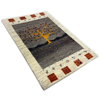 Gabbeh rug Lori: angled view of rectangular rug with yellow tree motif
