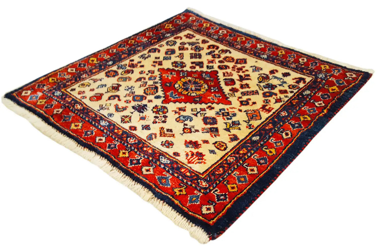 Qashqai exclusive rug with a red, blue, and beige pattern, surrounded by a border