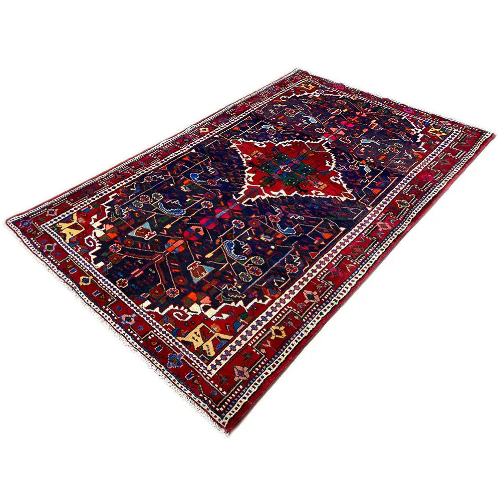 Rectangular Hamadan rug with a blue center and red-green ornamental borders.