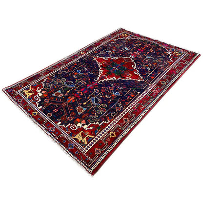 Rectangular Hamadan rug with a blue center and red-green ornamental borders.