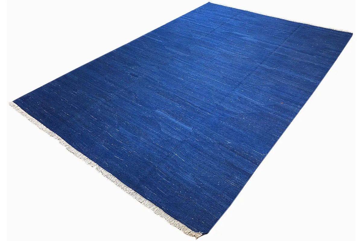 Blue kilim rug with fringes, diagonally spread-out view