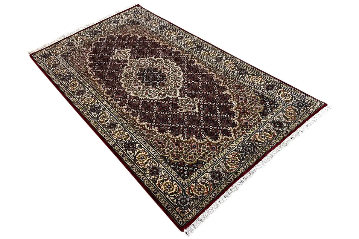 Indo-Tabriz carpet: diagonal view with ornamental border and medallion