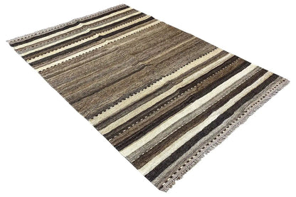Striped rug, spread out diagonally, with gray, beige, and brown stripes and fringes.