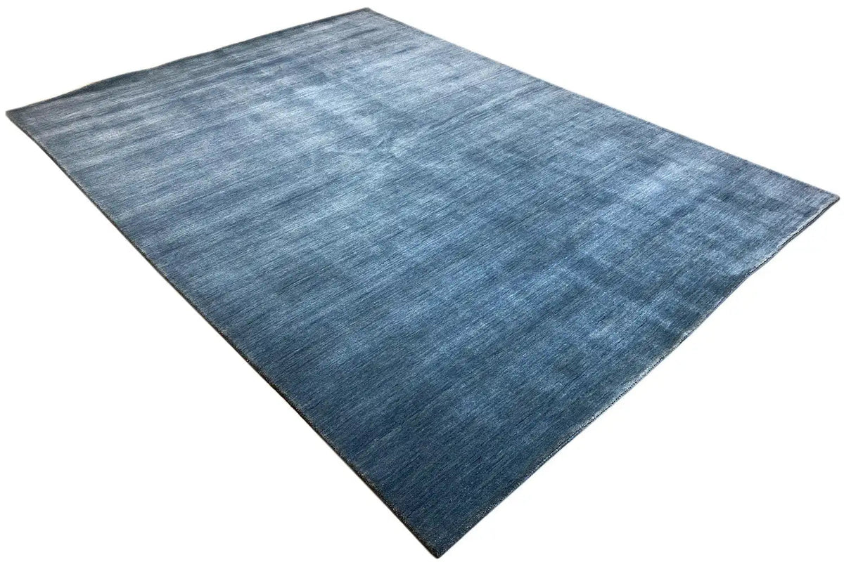 Blue Gabbeh rug, spread diagonally, uniform weave texture