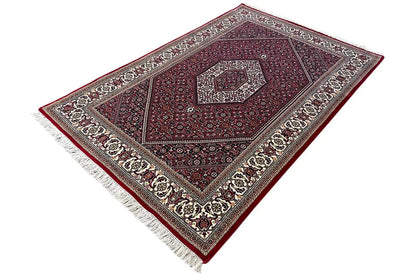 Bidjar rug (185x124 cm) - oblique overall view, muted colors and fringes along the edge