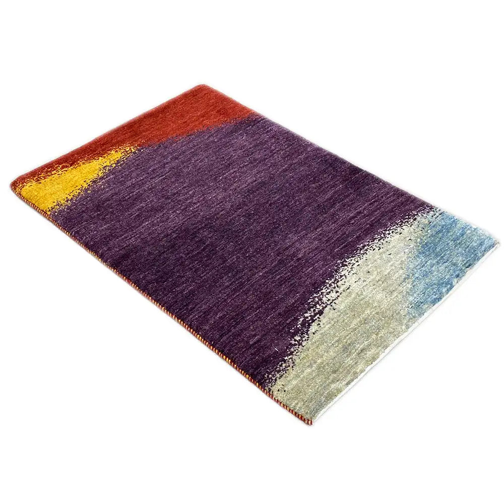 Gabbeh rug with a purple horizontal field, red and yellow accents, and a blue-and-white area