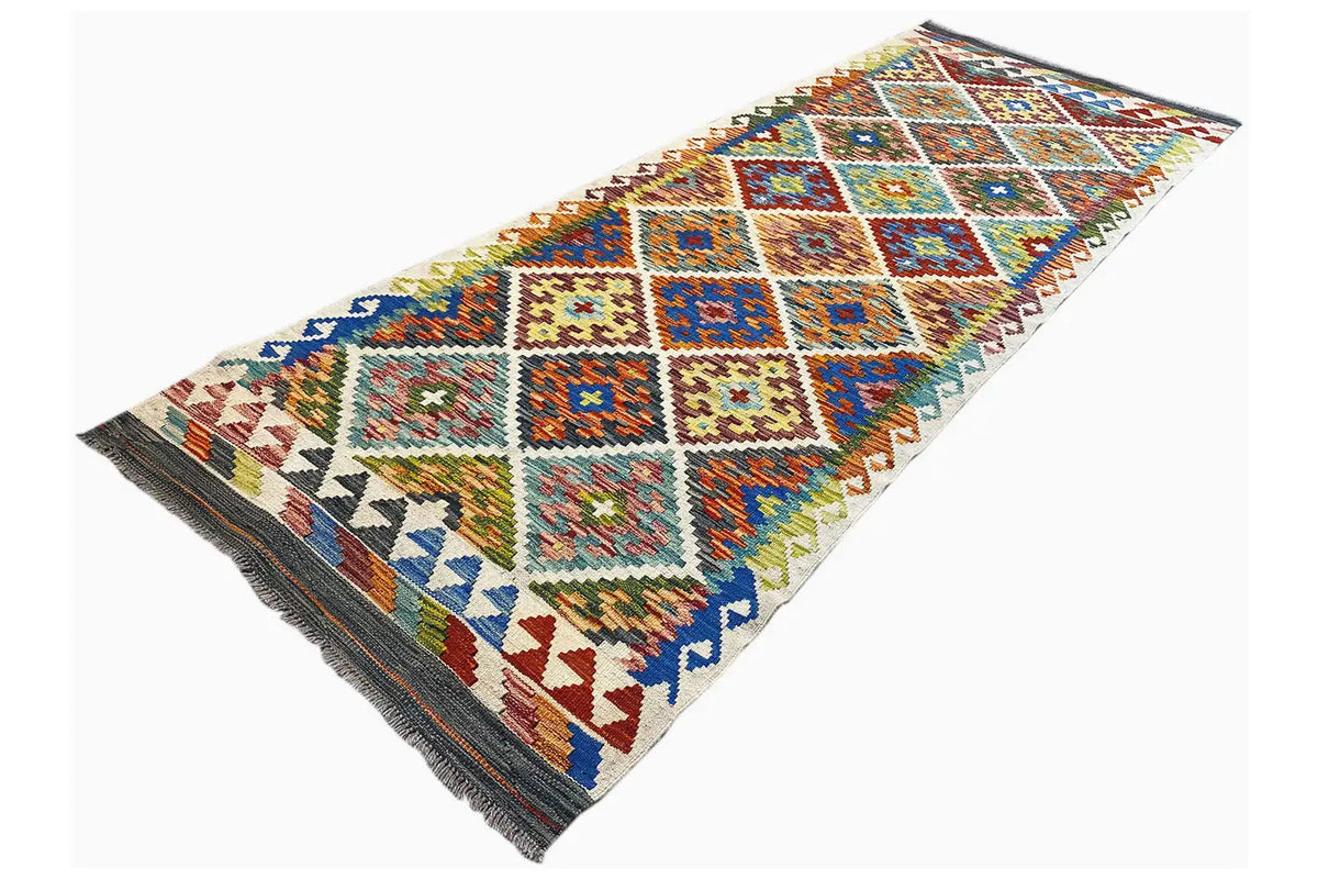 Afghan runner with patchwork-style squares in blue, orange, green, and yellow, fringe