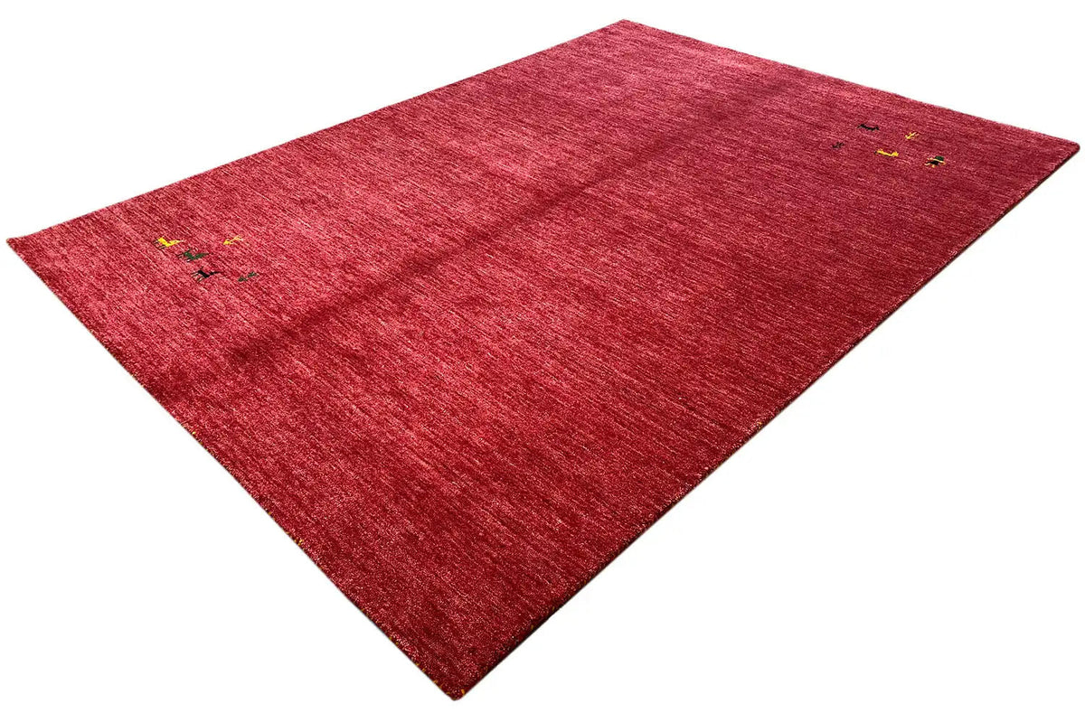 Red Gabbeh rug with small multicolored ornaments, diagonal view
