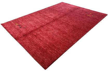 Red Gabbeh rug with small multicolored ornaments, diagonal view