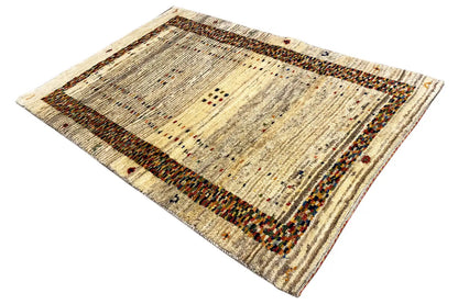 Gabbeh rug with a striped center field and brown border strip