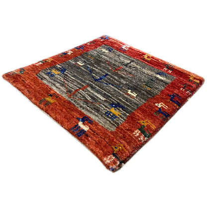 Square Gabbeh rug, reddish brown with a gray center and multicolored cross ornaments
