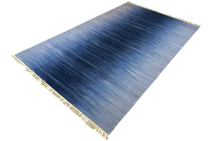 Blue kilim dhurrie rug, flat-weave, clear color gradient in blue, fringes along the edges