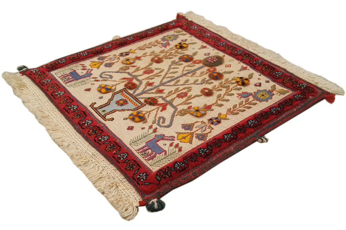 Decorative cushion cover with red border detail, natural-colored base, and colorful ornaments