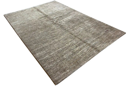 Gabbeh rug: light beige-gray pile with irregular mottling and a narrow border