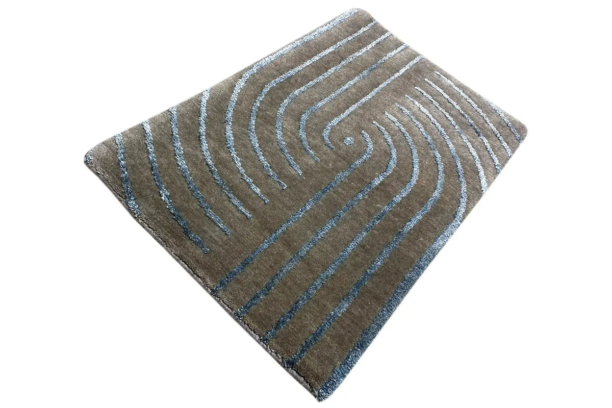 Designer rug with turquoise-blue swirling lines, laid out in a rectangle with rounded corners