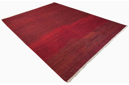 Red kilim rug, square view, with a subtle pattern and short white fringes