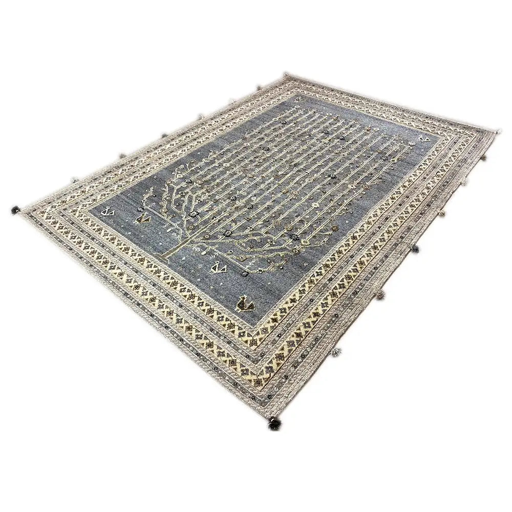 Blue-gray rug with gold-colored lines, a wide border, and tassels