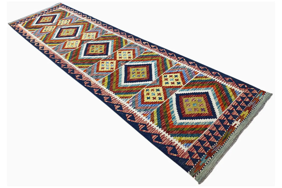 Kelim Afghan runner with geometric pattern and colorful border, diagonal view