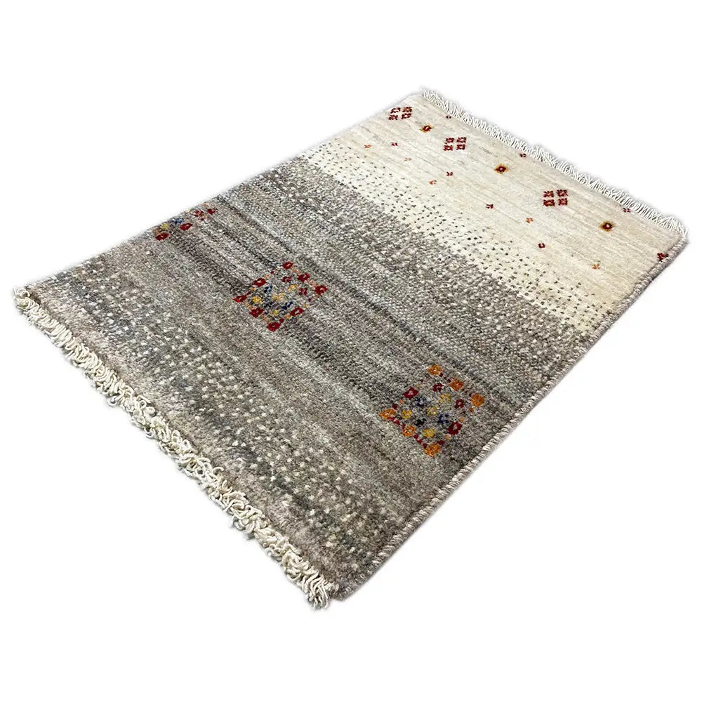 Gabbeh rug with a light beige background, gray areas, colorful square motifs, and fringes