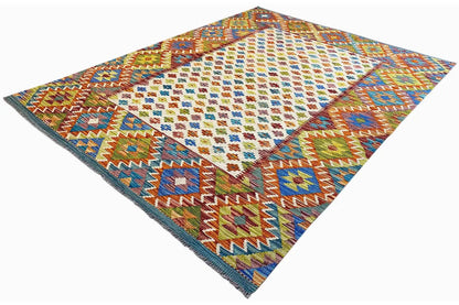 Afghan kilim rug at an angle with colorful diamonds and a distinctive edge border