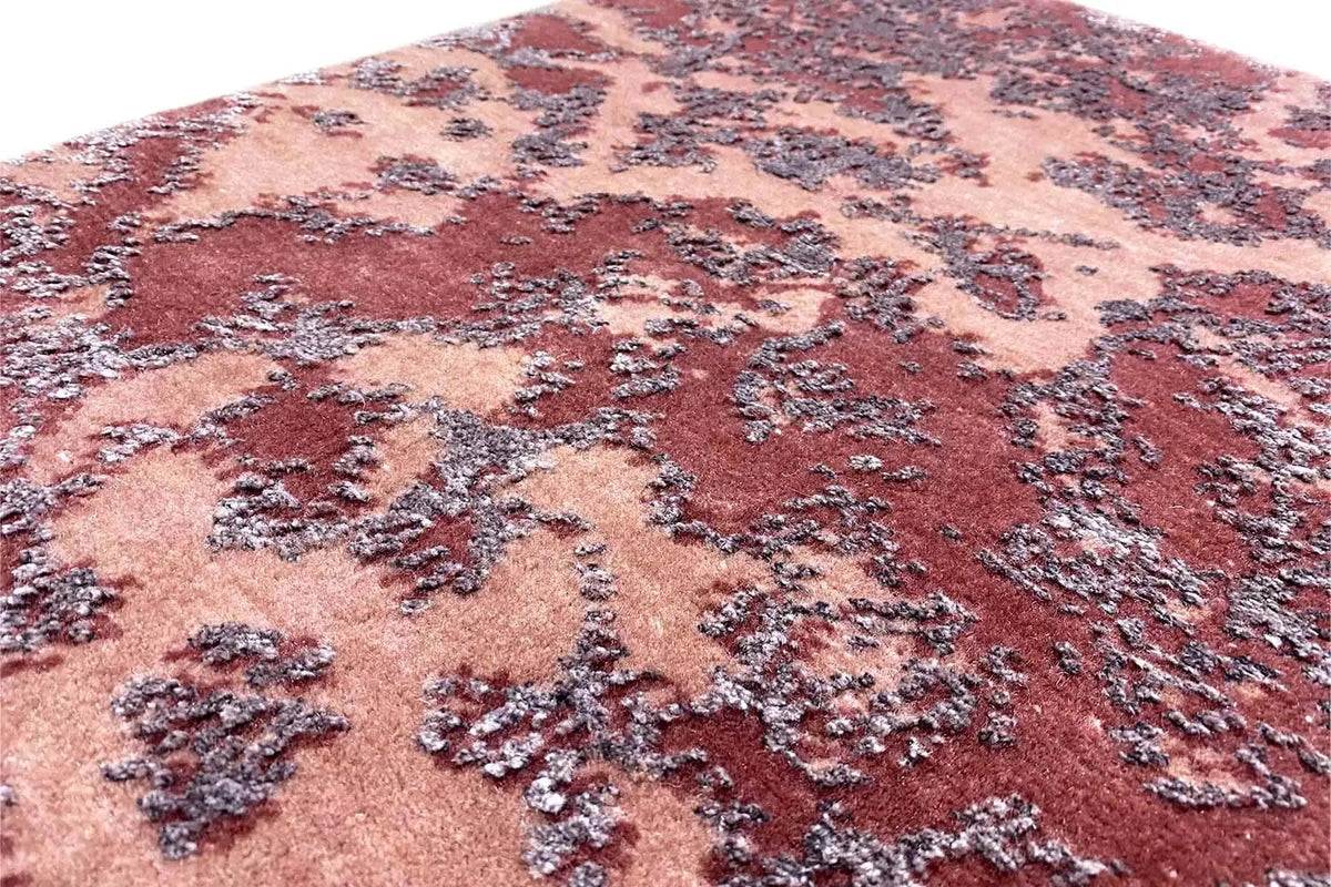 Designer rug: close-up view with a contrasting vintage pattern in burgundy, beige, and dark blue