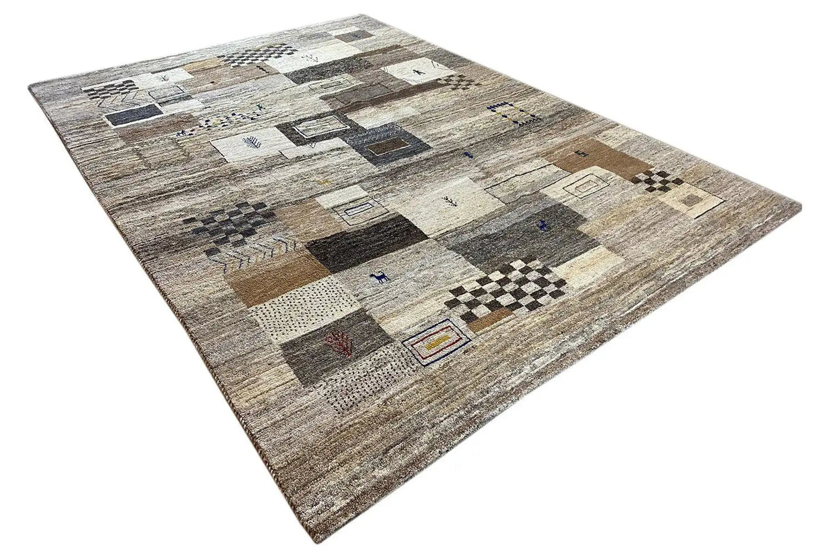 Gabbeh rug with a patchwork look made of rectangles and squares, from light gray to beige
