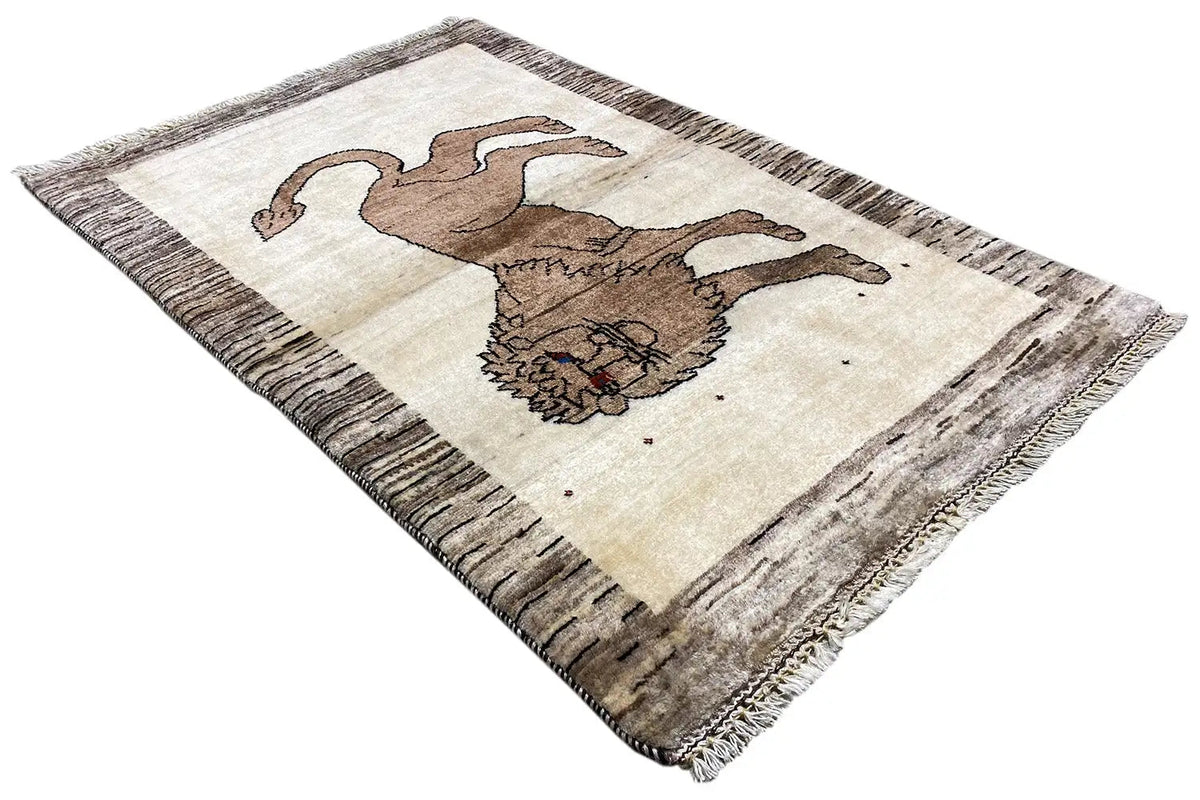 Gabbeh rug with lion motif, light beige background, taupe border, fringes