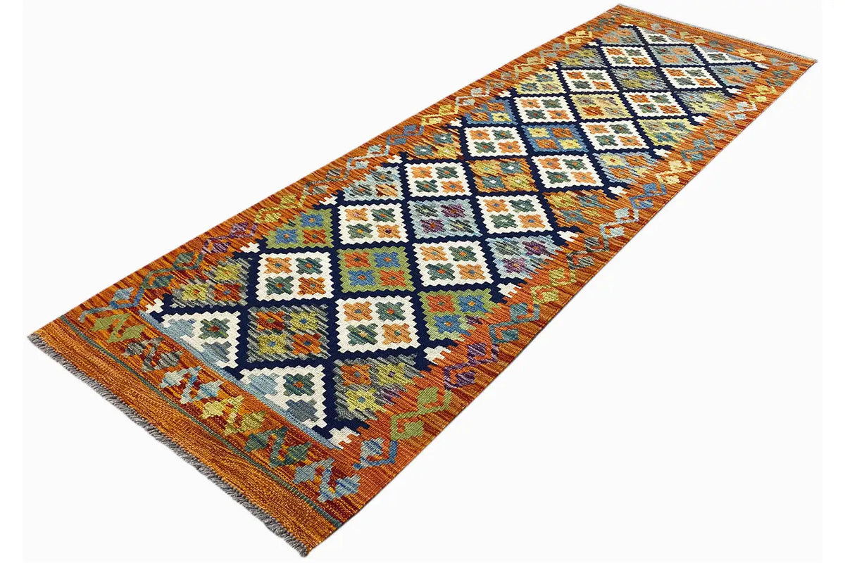 Afghan kilim runner at an angle, blue-white and orange ornaments