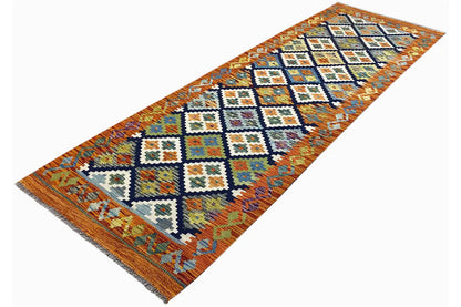 Afghan kilim runner at an angle, blue-white and orange ornaments