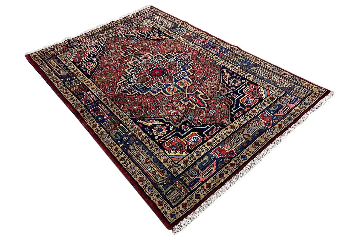 Hamadan rug with a red ornamental center and dark blue border