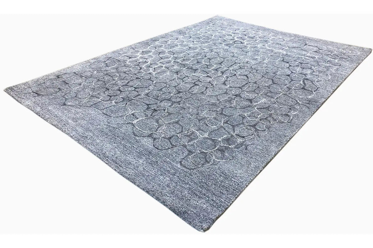 Hand-tufted rug in blue-gray with an even raised pattern and short pile texture