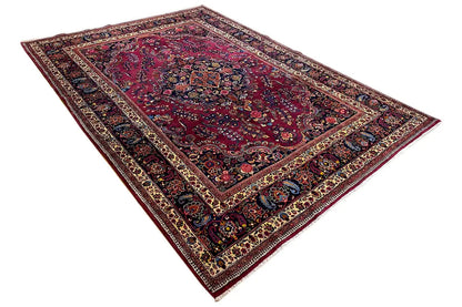 Rug with a deep red center, dark blue borders, and geometric ornamentation