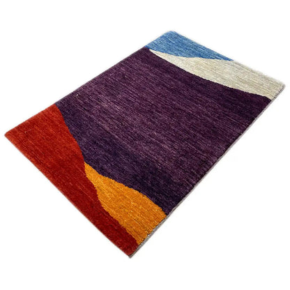 Gabbeh rug spread diagonally: dark purple with red and yellow bands of color