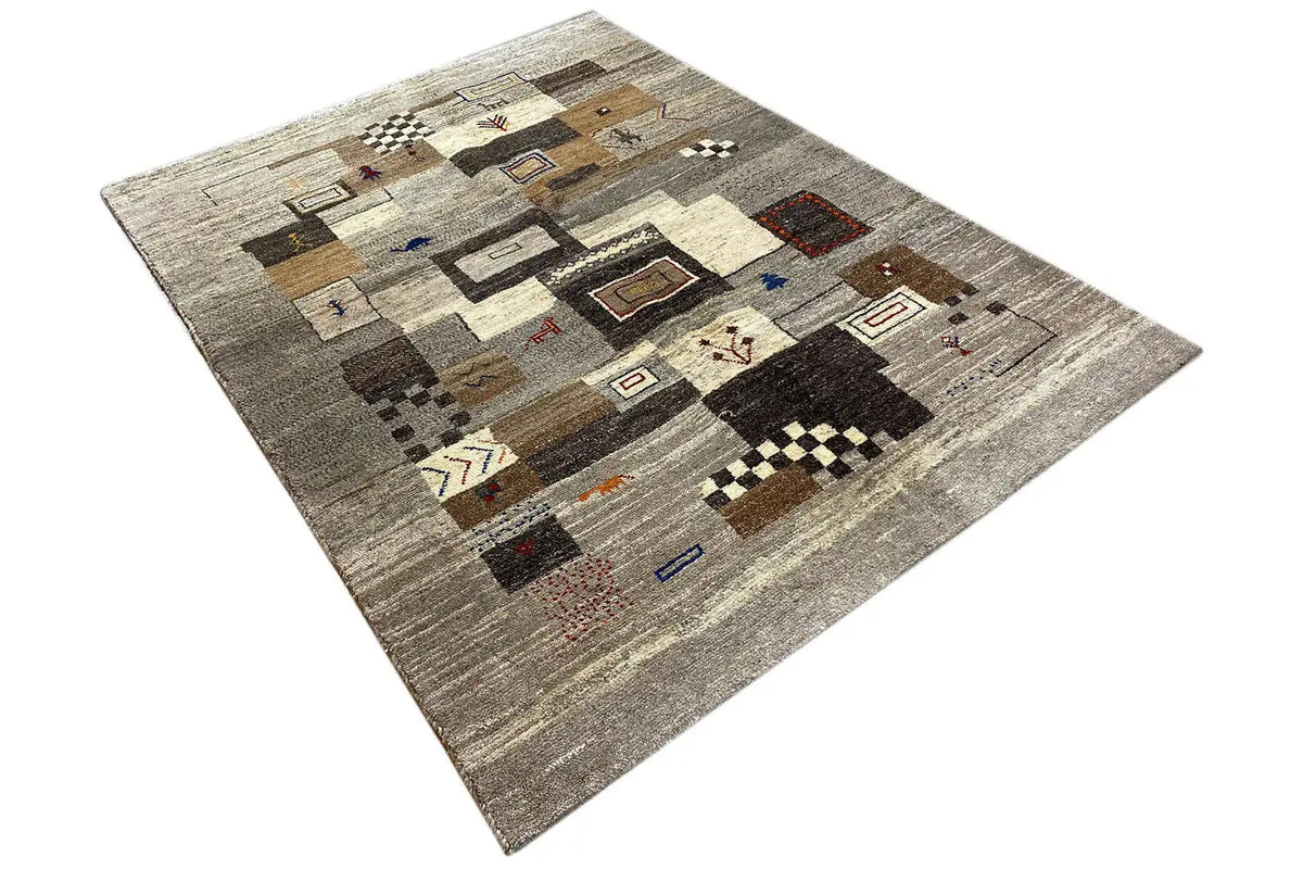 Gabbeh rug with a beige pile, contrasting blocks, and colorful details.
