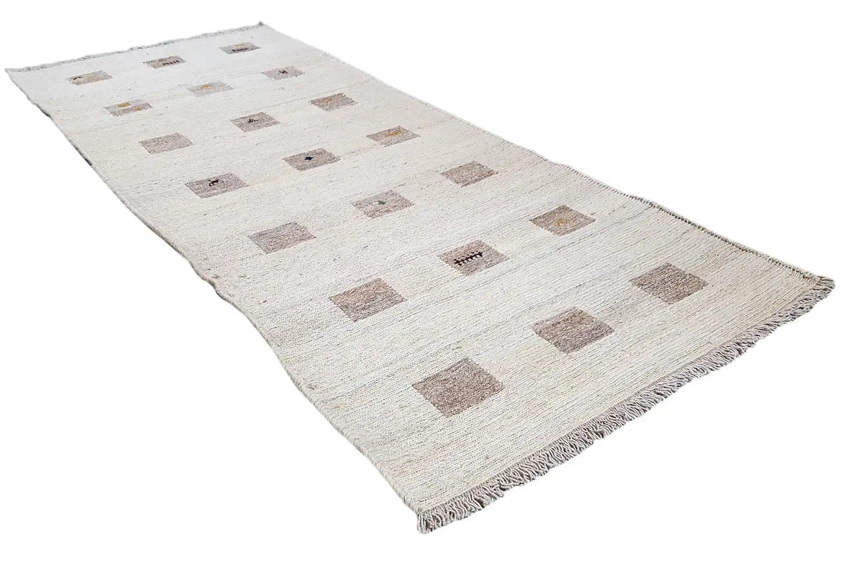 Kelim runner with a beige patterned background and brown squares, frayed edges