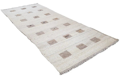 Kelim runner with a beige patterned background and brown squares, frayed edges