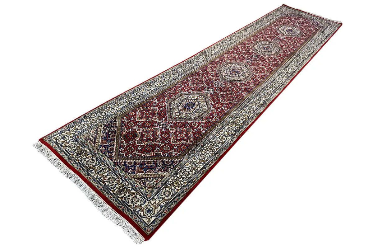Bidjar runner, long rectangle with a red medallion field and dark blue decorative border