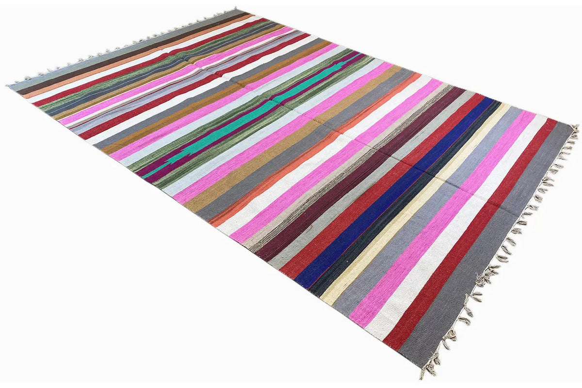 Kelim dhurrie rug in side view, striped in bold colors, with fringes