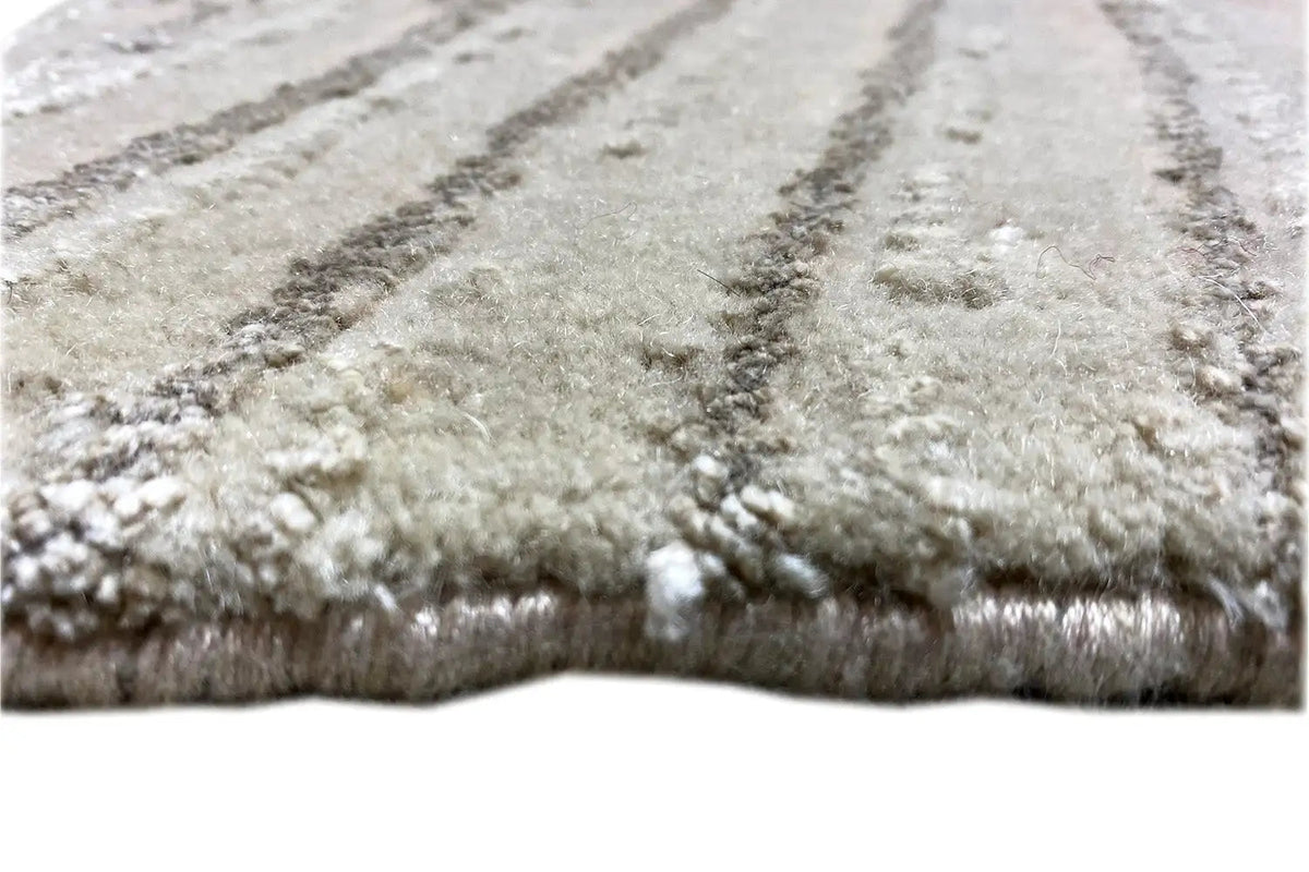 Close-up: Light gray carpet with a short pile and shimmering wave pattern